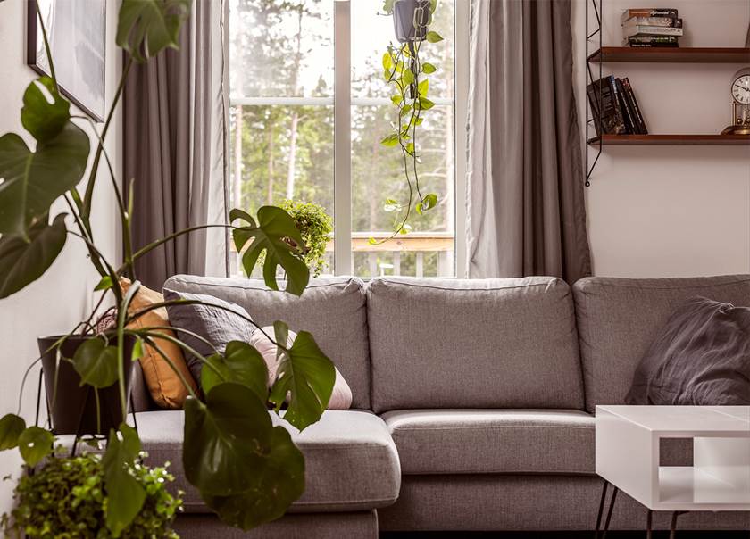 Grå soffa hemma hos familjen Engstöms BoKlok lägenhet