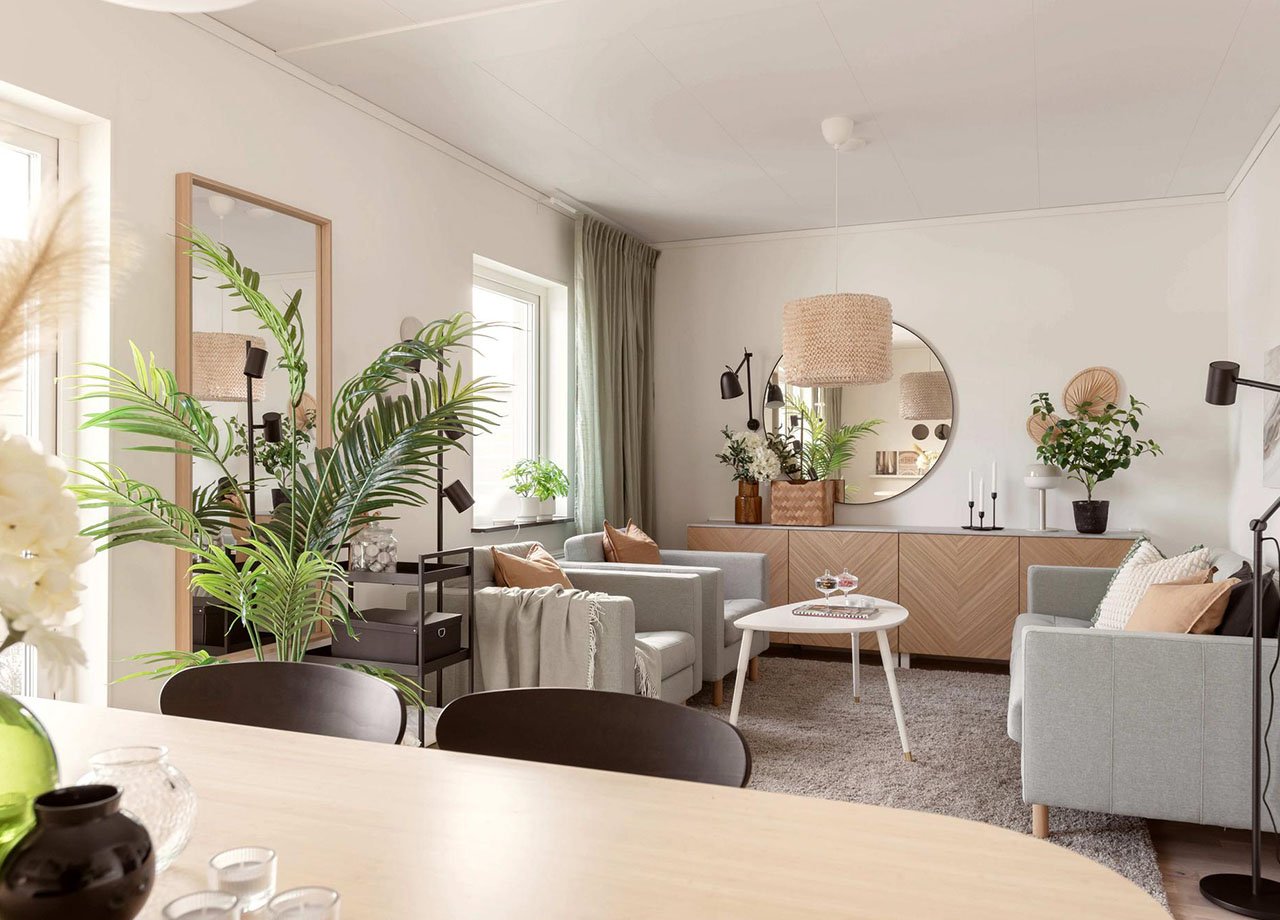 Vardagsrummet med plats för soffa, soffbord, fåtöljer och matbord i BoKlok radhus 117 kvm