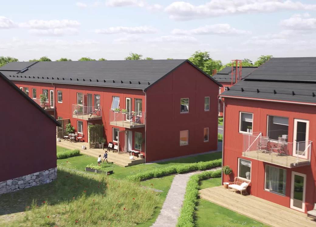 Röda lägenhetshus i två våningar.